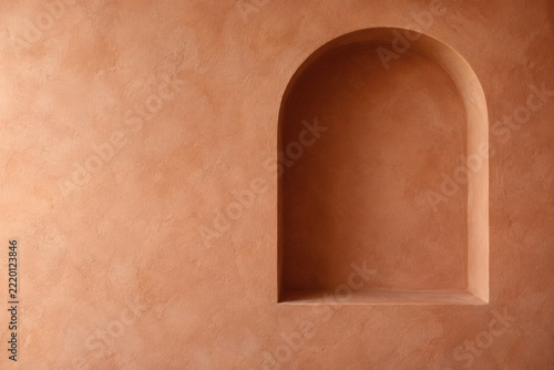 Empty arched alcove with warm plaster textures