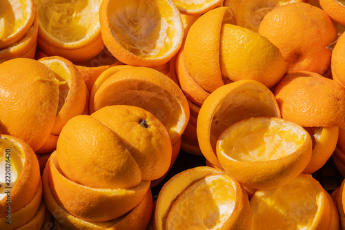 Peeled orange rinds piled together in closeup setting