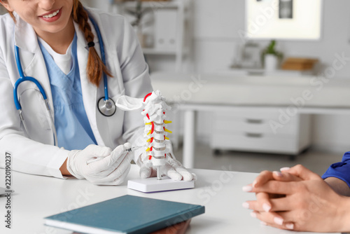 Spinal pain treatment and medical consultation, doctor explaining cervical sp...