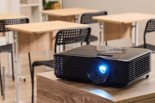 Education technology and classroom learning, digital projector on desk in emp...