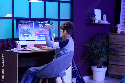 Gaming addiction and digital entertainment, boy playing racing video game on ...
