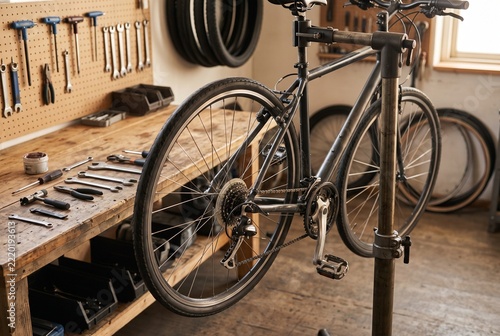 Bicycle wheel and tools in a tidy repair workshop