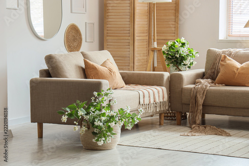 Home interior design and comfort, cozy living room with beige sofas and bloom...