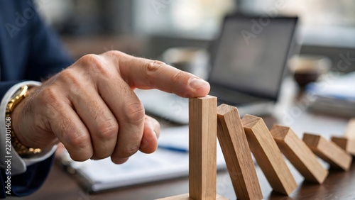 Risk Management Finger Stopping Domino Effect On Office Desk