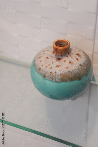 top view antique gradient brown and green ceramic vase on a glass shelf, white marble wall background, object, decor, fashion, copy space