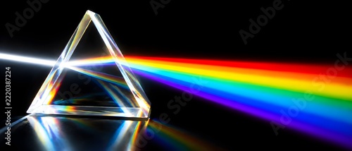 Crystal prism flare splitting white light into vivid spectral bands on black