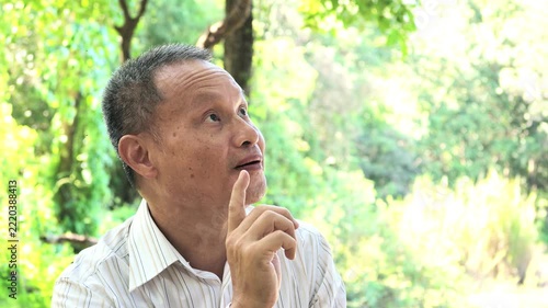 Slow Motion of Thai Senior Man Pointing Up with a Sudden Idea