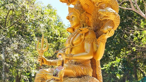 Slow Motion Tilt Up Shot of Golden Lord Vishnu Statue