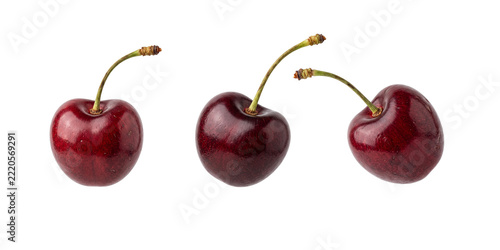 Three fresh red cherries with stems isolated on a transparent background