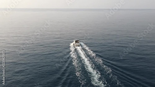Aerial view of a motorboat cruising on the calm open sea