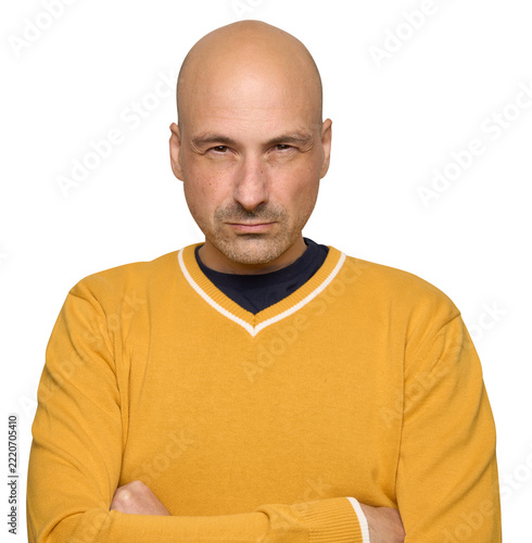 Bald man with narrowed eyes a suspicious expression on his face. Isolated