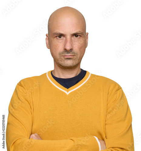 Serious bald man in yellow sweater. Isolated