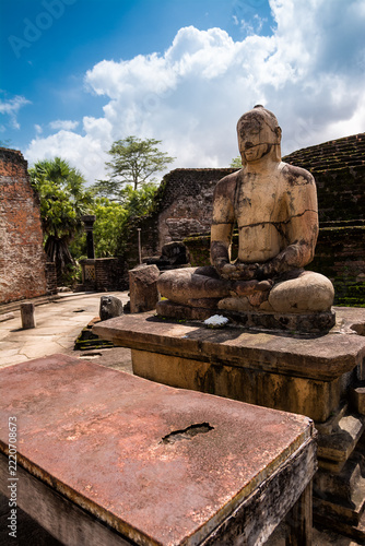 Ancient Buddha Statue in Polonnaruwa with Crumbling Brick Ruins