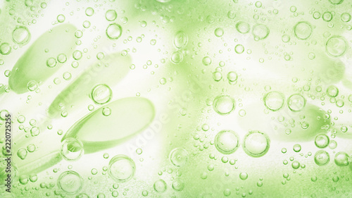 Green cosmetic gel macro texture background with oxygen bubbles