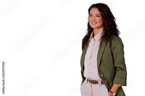Confident business woman looking away, smiling with hands in pockets, posing for professional success
