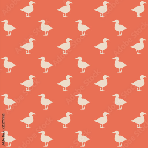 Seamless pattern created from small cream standing seagulls on a terracotta background