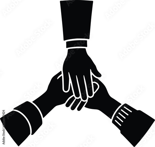 Three Colleagues Join Hands in a Team Huddle to Celebrate Shared Success