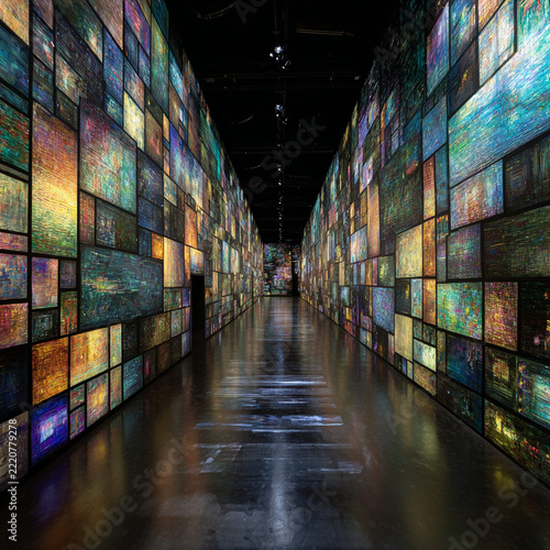 Long corridor lined with glowing colorful digital art screens