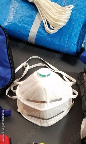 White respirator mask rests on dark surface
