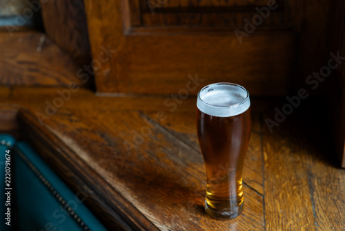 High angle view of non alcoholic light beer on dark wood bar counter