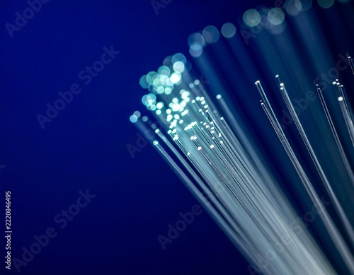Fiber optic cables glowing against a dark blue background