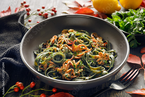 Baby octopuses with seaweed pasta, seasoned with white wine, garlic and chili, and sprinkled with fresh parsley.