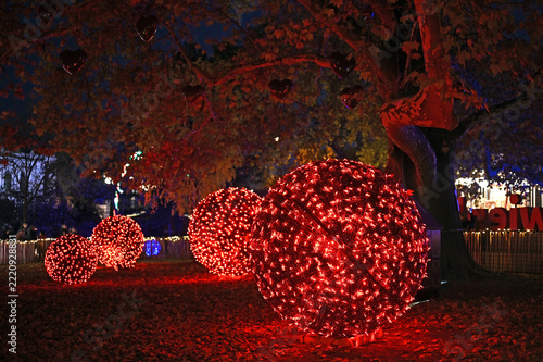 Photography Illuminated Red Christmas Light Orbs and Heart Tree at Traditional Holiday Marke