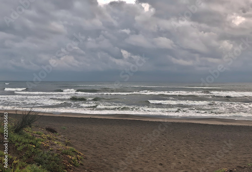 Scenic view of the rough winter sea under a cloudy sky.