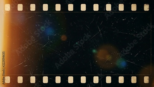 Vintage 35mm strip frame with heavy scratches, dust particles, light leaks, and analog texture on a dark background, for cinematic effects