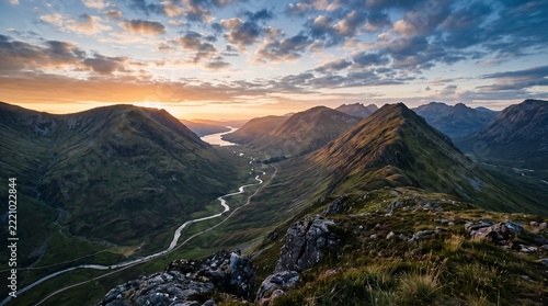 Scenic sunset over scottish highlands valley with winding river and