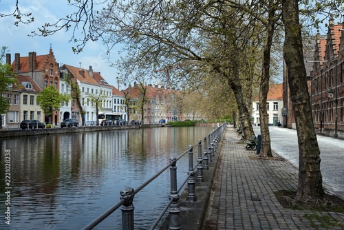 Scenic spring cityscape of a tranquil canal and traditional architecture in the old town of Bruges