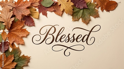 Autumn leaves frame the word blessed in elegant calligraphy on a white background