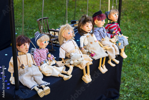 Series of string puppets representing people sitting on table between shows scheduled during a public festival, Quebec City, Quebec, Canada