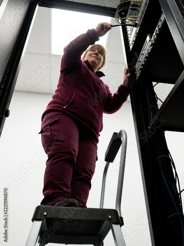 Woman Technician Working on Server Rack