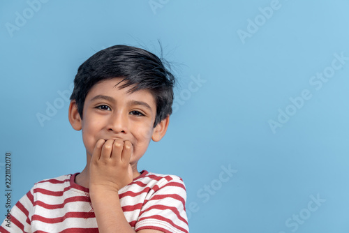 Shy indian boy feeling childhood emotion and surprise
