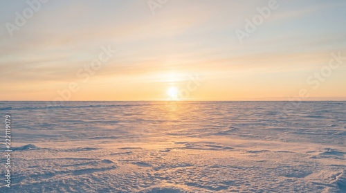 Sun over a snowy horizon
