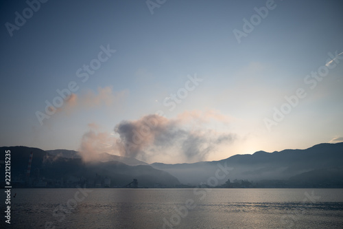 Morning fog over mountain and wide calm sea before sunrise in June