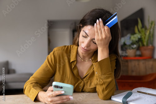 Fotografie Woman feels stressed about rejected online payment, financial problems, blocked bank account, or overdraft notification