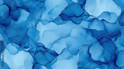 Abstract blue watercolor texture with fluid, organic shapes and varying shades, creating a calming and artistic background.