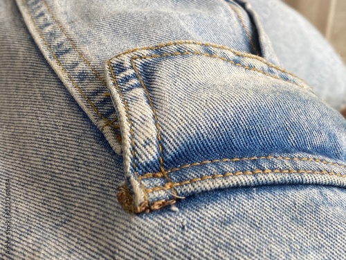 Close Up of Blue Denim Jeans Pocket with Golden Stitching Detail