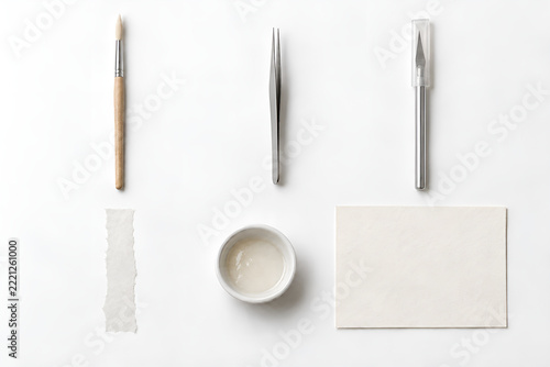 Six paper repair tools and materials on white background