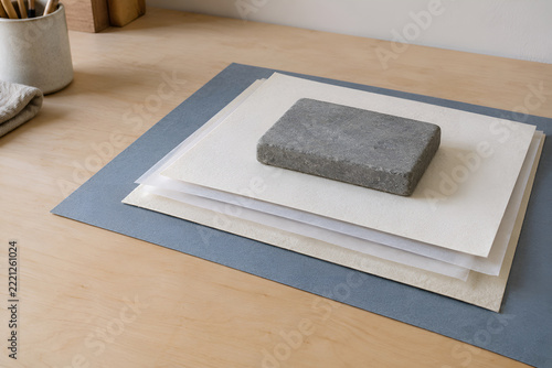 Paper drying between blotter sheets under a flat weight