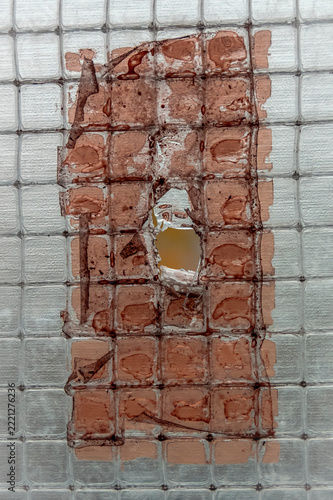 A torn patch on a polycarbonate greenhouse on an autumn day