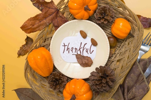 Thankful plate with autumn harvest decoration for thanksgiving