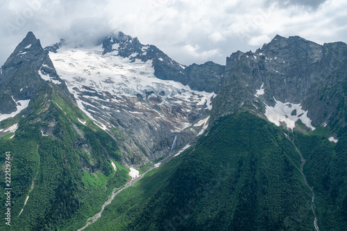 Mountains with snow and trees in the background