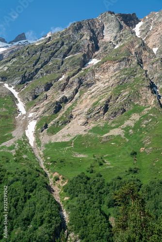 Green-sloped mountains with sunny cliffs
