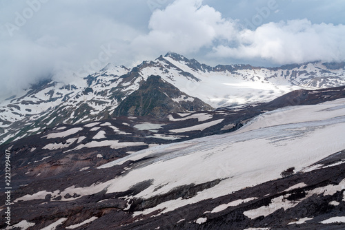 Mountains with glaciers and distant clouds