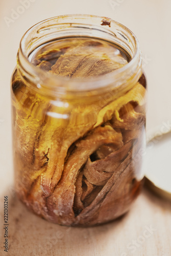 bottle of salted anchovies in olive oil