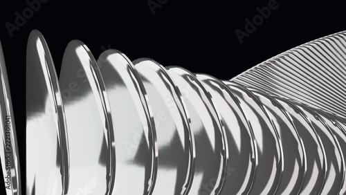 Close-up of mirror chrome discs receding into a ribbed tube on black