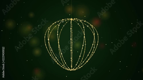 Glowing golden Christmas ornament animation hanging with sparkling lights on dark green background